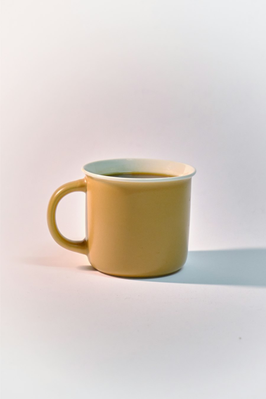 Yellow coffee cup on white table